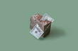 © Yaroslav Danylchenko/Stocksy - Dollar stuck in grunge natural stone block.