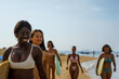 © Jovo Jovanovic/Stocksy - Women surfers walk down beach together