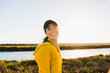 © Christine La/Stocksy - Smiling Woman Wearing Visor On Hike