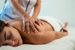 © David Prado/Stocksy - Masseuse doing massage to client