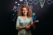 © VICTOR TORRES/Stocksy - Smiling blonde woman with folder in modern creative office
