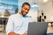 © VICTOR TORRES/Stocksy - Cheerful analyst man using laptop in office
