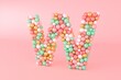 © Bruno Tornielli/Stocksy - Letter W made of glass balls, pastel pearls, crystal jewels and gold.