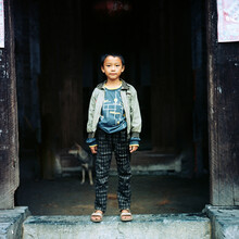 A Little Boy Standing On The Threshold