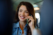© Jovo Jovanovic/Stocksy - Smiling attractive female talking on smart phone while commuting