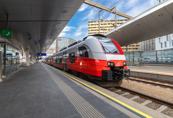 Wall Mural - high speed train on the train station at sunset in vienna, austria. beautiful red modern intercity p