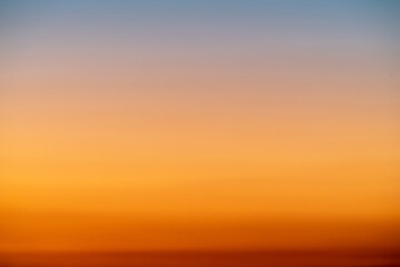 the dramatic colors of the sunset in the sky gradient from blue to orange.