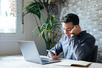 Unhappy young man looking at phone, feeling nervous of bad device work, internet disconnection, lost data or inappropriate online content. Anxious male user dissatisfied with application or service..