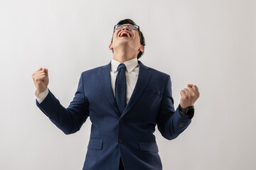 Portrait of excited Asian businessman in glasses standing with win success and excited is positive, expression and emotion isolated on white background