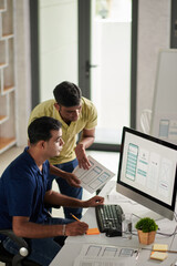 Wall Mural - ui and ux designers discussing mobile application interface for new project