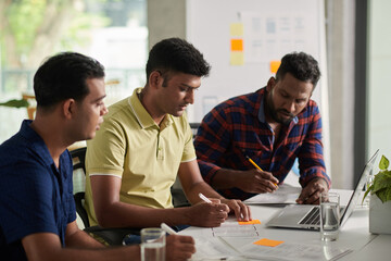 Wall Mural - team of developers working on prototype of new mobile application