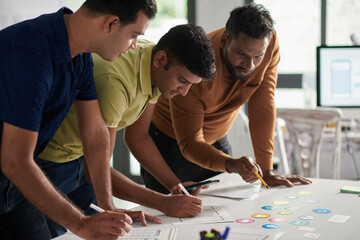 Wall Mural - team of ux designers choosing icons for new mobile application