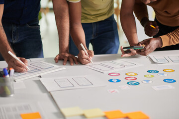 Wall Mural - hands of ui and ux designers creating design for new mobile app