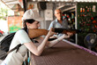© Arsentyev Vladimir - A girl in a cap picks up a rifle and aims at a target in a shooting gallery in the summer