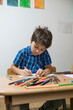 © Cavan Images - Boy colouring with coloured pencils Munich, Germany