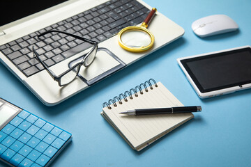 Wall Mural - Eyeglasses, laptop computer and other business objects.