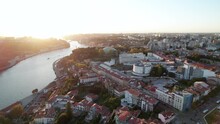 Beautiful Aerial Establishing Shot At Sunset Of Porto, Portugal. Portuguese Town On The Border Of A River