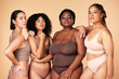 © Nina L/peopleimages.com - Body positive, diversity and portrait of women group together for inclusion, beauty and power. Underwear model people or friends on beige background for skincare, pride and motivation for self love