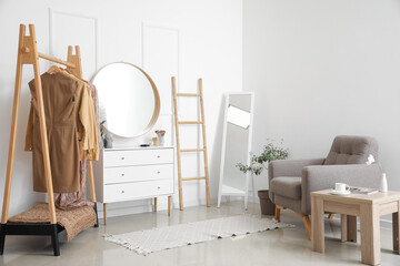 Canvas Print - Interior of stylish makeup room with mirrors, clothes and armchair