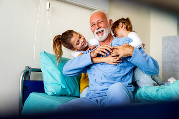 Family visiting senior male patient in hospital bed. Healthcare, support, family concept