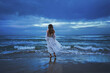 © layue - Woman in white dress on a sea backgorund