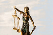 Justice statue on wooden background