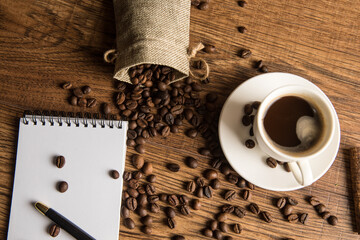 Canvas Print - Cup of coffee, notebook and coffee beans