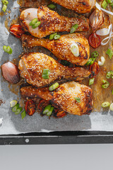 Wall Mural - Baked chicken legs. Baked chicken drumstick on paper