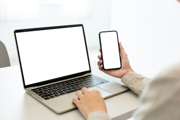computer screen,cell phone blank mockup.hand woman work using laptop texting mobile.white background for advertising,contact business search information on desk in cafe.marketing,design