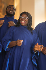 Wall Mural - Black Christian Female Gospel Singer Singing, Happy to be Spreading the Love of Lord Jesus Christ. Cheerful African American Woman in Blue Robe in Sunday Church with Music Bringing Peace, Hope, Love