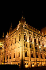 Wall Mural - Evening photo of the Parliament building in Budapest.The majestic Saxon architecture is illuminated with warm yellow light