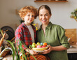 © JenkoAtaman - Loving young mother nad son boy with wicker basket full of painted Easter eggs