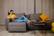 © Ankor_stock. - Happy indian or arabian girl resting on cozy sofa at home, listening to music