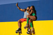 Cheerful couple with roller skating outside. Fun sexy boyfriend and girlfriend taking selfie photo
