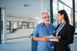 © Halfpoint - Young business woman shaking hand with elderly doctor.