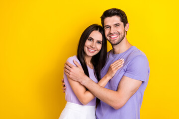 Canvas Print - Photo of idyllic peaceful positive partners hug toothy smile empty space isolated on yellow color background