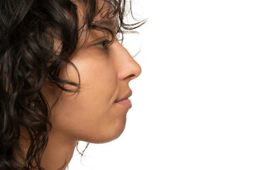 Wall Mural - close up, profile, side view of beautiful young indian woman without makeup on a white background