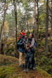 © Maskot - Happy family standing with each other in forest during vacation