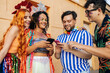 © kleberpicui - Brazilian Carnival. Group of friends celebrating carnival party using smartphones