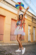 © kleberpicui - Portrait of a Brazilian woman during a carnival block. Woman playing with confetti and Frevo umbrella.