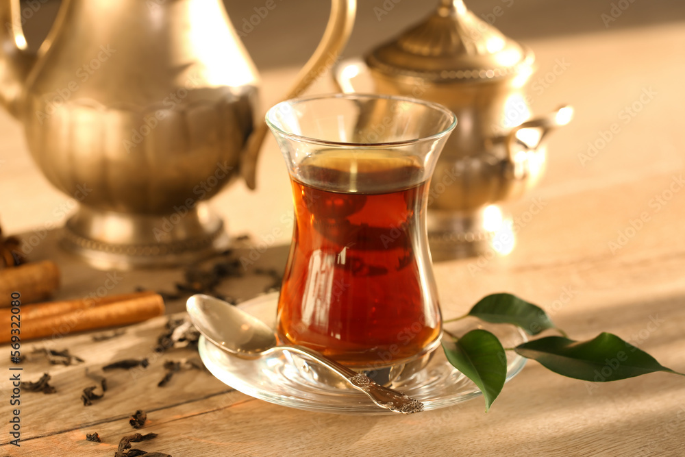 Glass cup of Turkish tea on wooden table