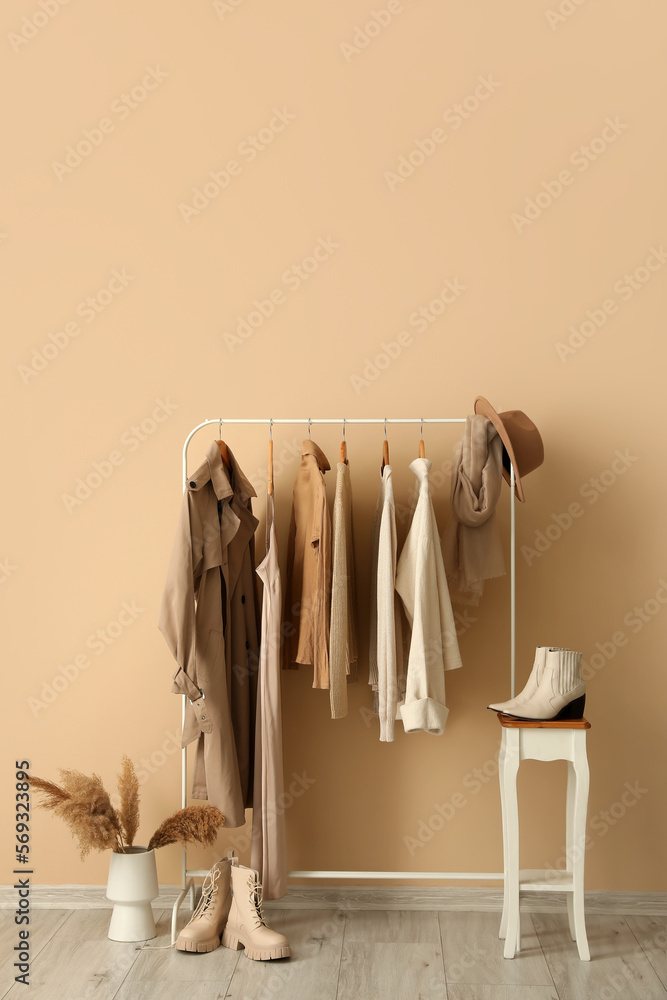 Rack with stylish clothes in interior of dressing room