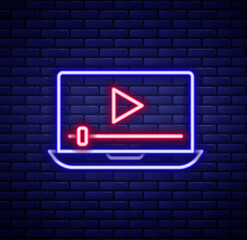 Canvas Print - Glowing neon line Online play video icon isolated on brick wall background. Laptop and film strip with play sign. Colorful outline concept. Vector