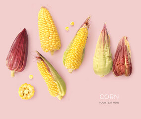 Wall Mural - Creative layout made of corn on the pink background. Flat lay. Food concept. Macro  concept.