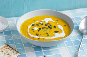 Wall Mural - Autumnal soup in bowl on grey background