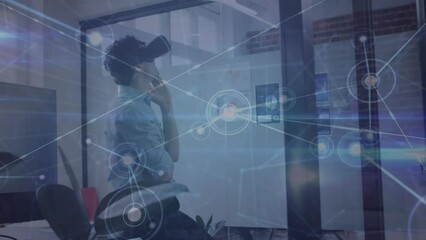 Canvas Print - Animation of network of connections over caucasian man wearing vr headset at office