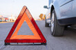 © Alan - hazard triangle at the side of a grey car, emergency reflective hazard triangle on the road