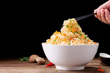 Poster - bowl of instant noodles or pasta. Delicious hot soup. Thai, Chinese, Japanese food arranged on table isolated on black background.