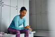 © Drazen - Pensive African American sportswoman in locker room at gym.