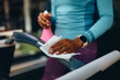 © Drazen - Close up of African American sportswoman disinfecting treadmill after working out in health club.
